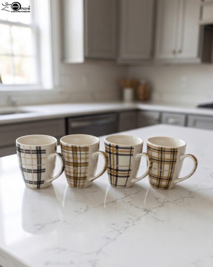 Set of four modern plaid ceramic coffee mugs displayed on a white marble kitchen countertop.