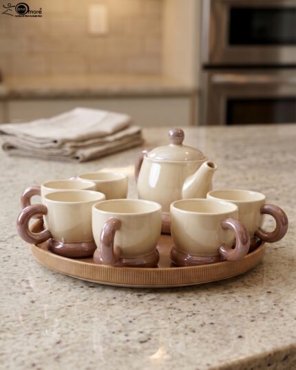 Beige and brown ceramic tea set with 6 cups, a teapot, and a rotating tray arranged on a kitchen counter