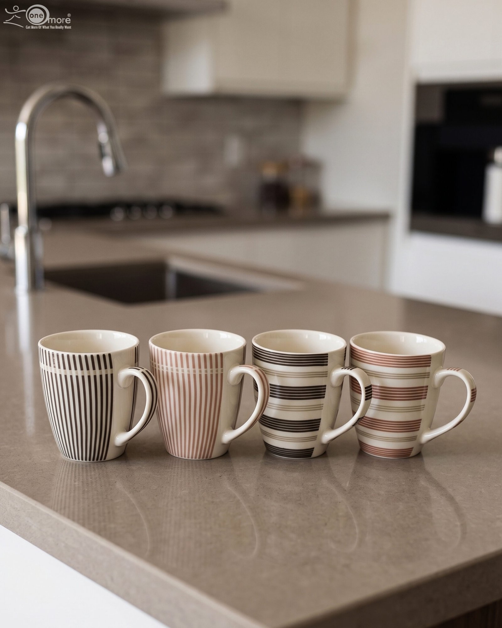 1 Four ceramic coffee cups with vertical and horizontal striped patterns lined up on a kitchen counter
