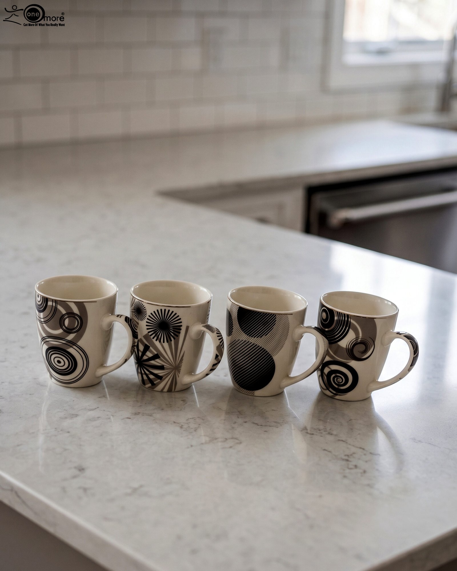 1 Set of 4 cream ceramic coffee mugs with distinct black geometric and swirl patterns displayed on a white marble countertop