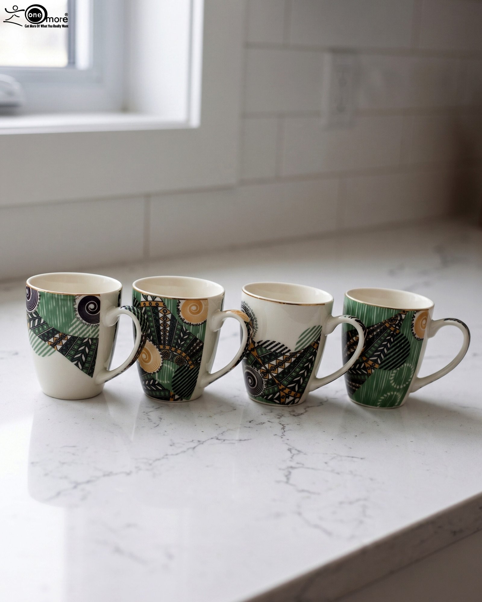 1 Four white ceramic coffee mugs lined up on a marble countertop with green, gold, and black abstract tribal patterns and comfortable handles.