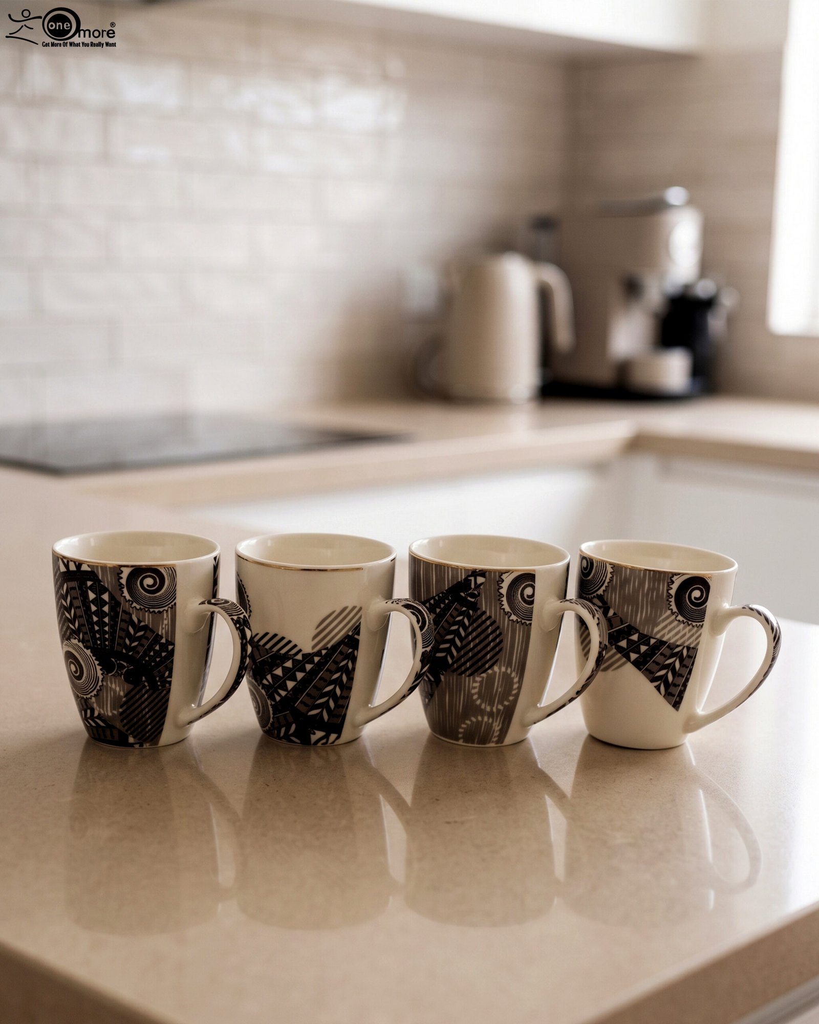 1 Set of 4 white ceramic coffee mugs featuring modern black geometric patterns lined up on a kitchen countertop.