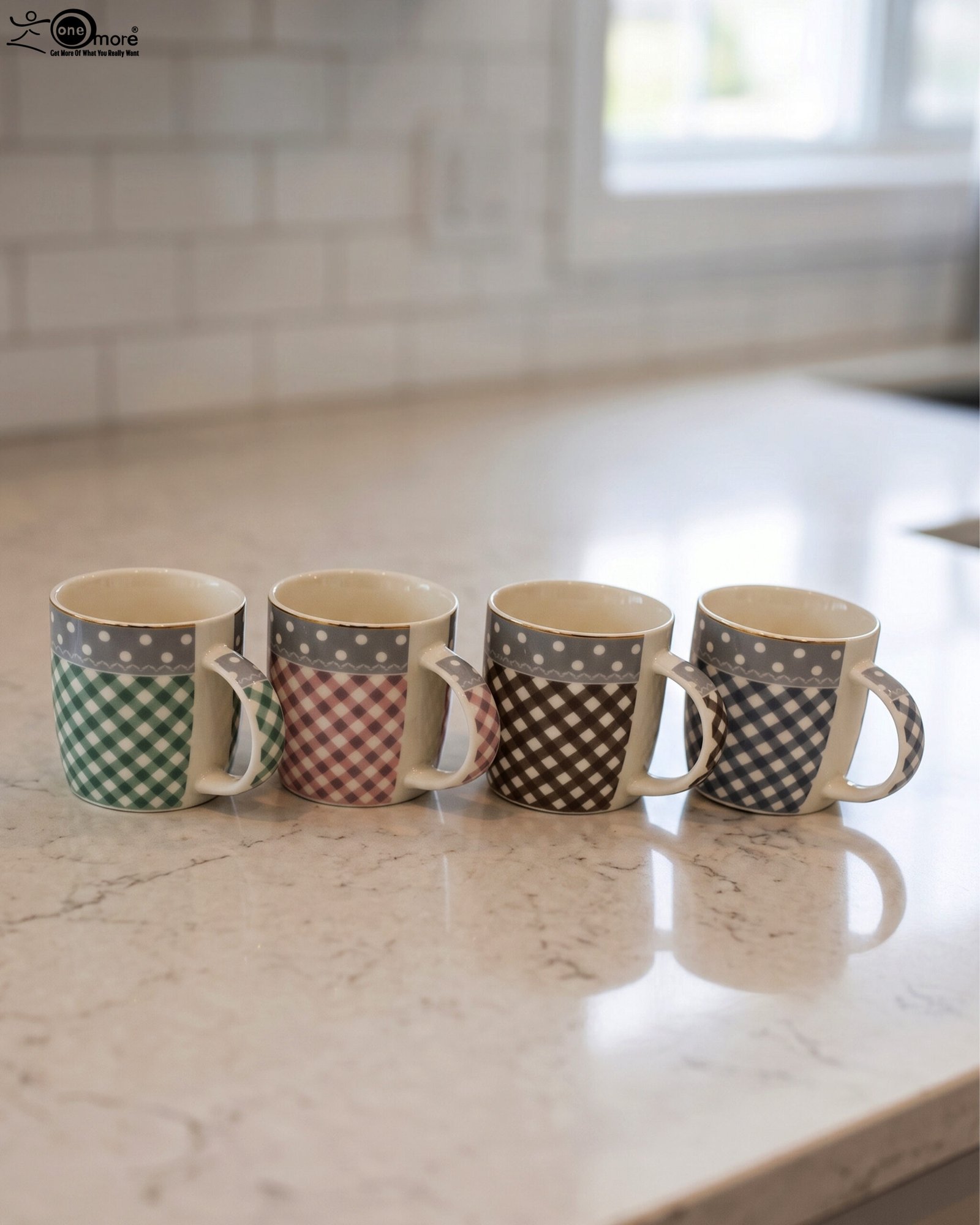 1 Four ceramic coffee mugs with gingham and polka dot patterns lined up on a marble countertop