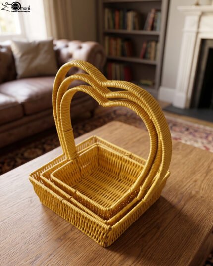 Set of 3 yellow woven rattan nesting trays with high arched handles stacked on a wooden coffee table.