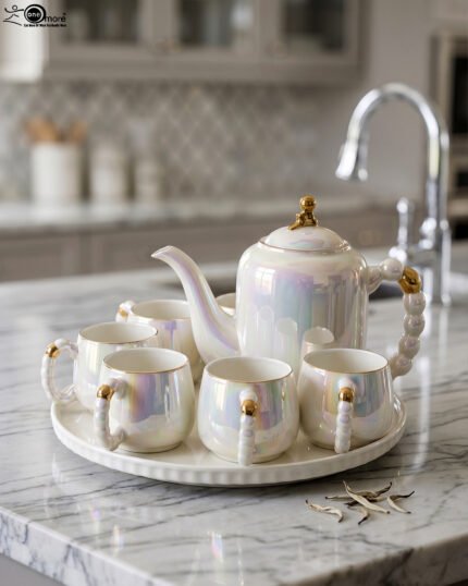 Luxury iridescent ceramic tea set with 6 cups, 1 kettle, and a rotating tray displayed on a marble kitchen counter
