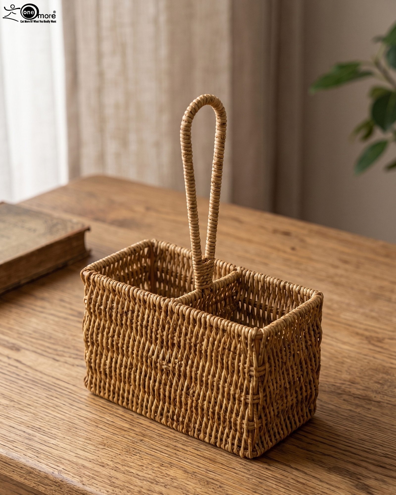 1 Handwoven rattan spoon holder basket with center handle and two compartments on a wooden table.