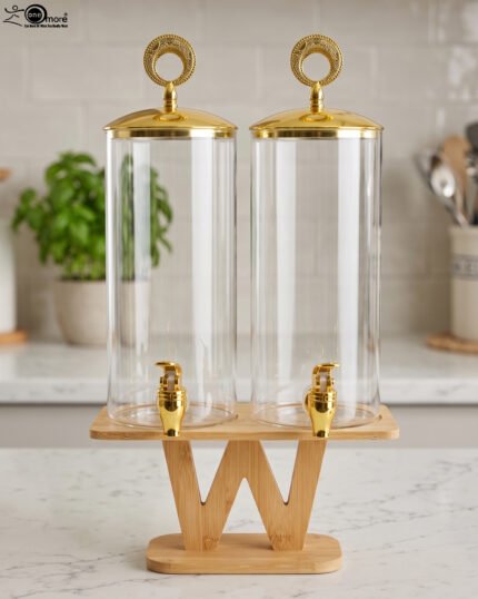 Two tall clear glass drink dispensers with gold spigots and circular gold finial lids resting on a wooden W-shaped stand.