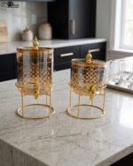Luxury amber glass beverage dispenser with intricate blue pattern on a decorative gold metal stand
