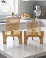 Ribbed amber glass beverage dispenser with gold tap and pineapple lid finial on a wooden stand