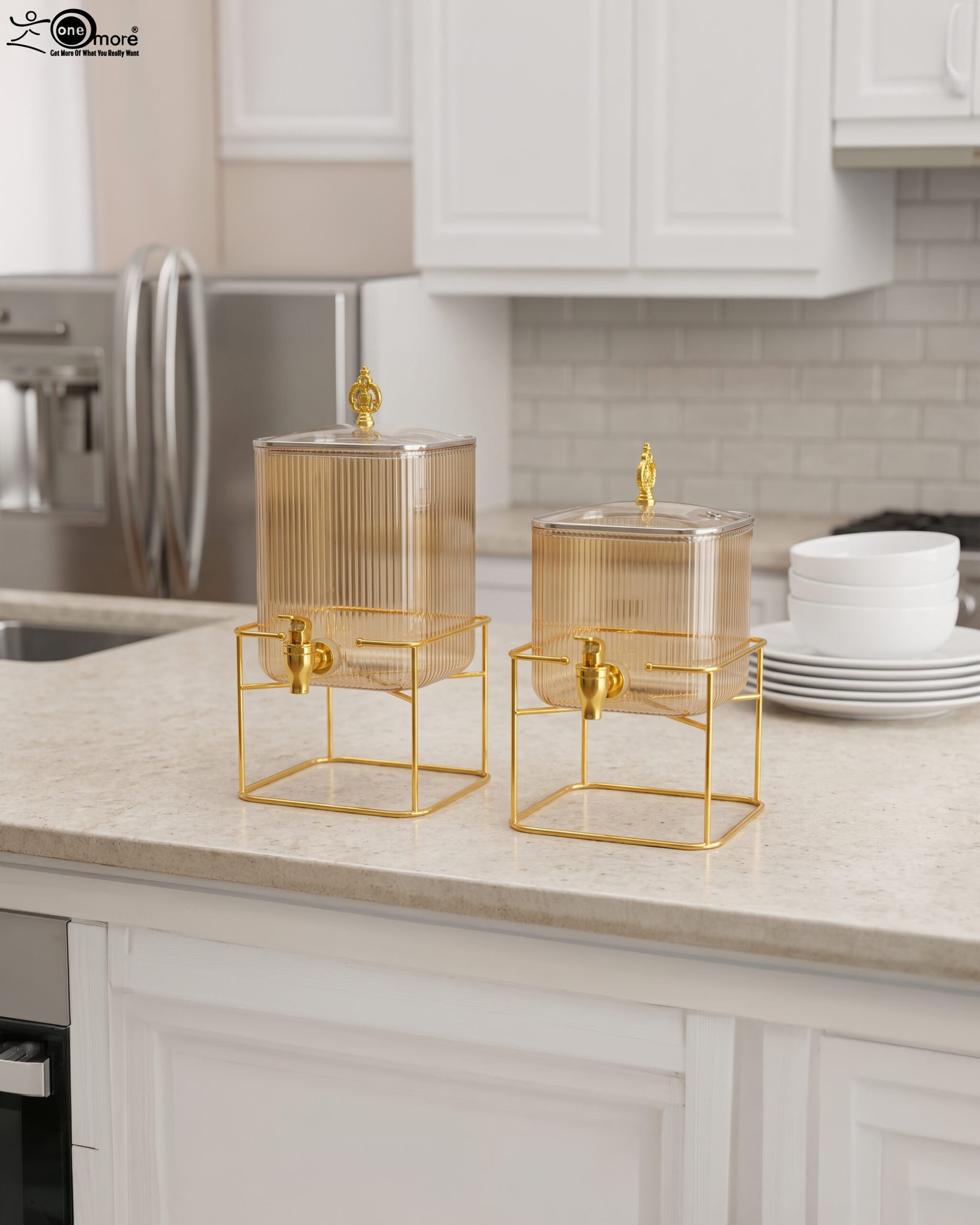 1 Two amber fluted glass beverage dispensers on gold metal stands resting on a modern kitchen counter