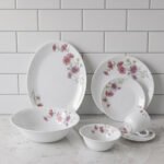 32-piece white printed dinner set with pink floral blossom design displayed on a white marble countertop