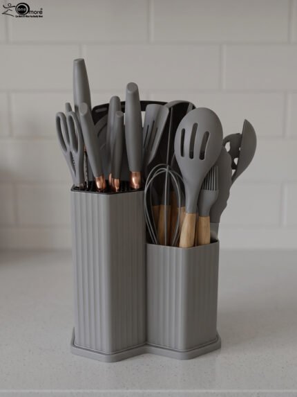 Grey 19-piece silicone kitchen utensil and knife set with wooden handles in a matching grey dual-compartment storage block.
