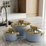 3-piece luxury insulated hotpot set in light blue with gold trim and clear glass lids displayed on a marble kitchen countertop.