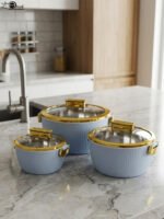3-piece luxury insulated hotpot set in light blue with gold trim and clear glass lids displayed on a marble kitchen countertop.