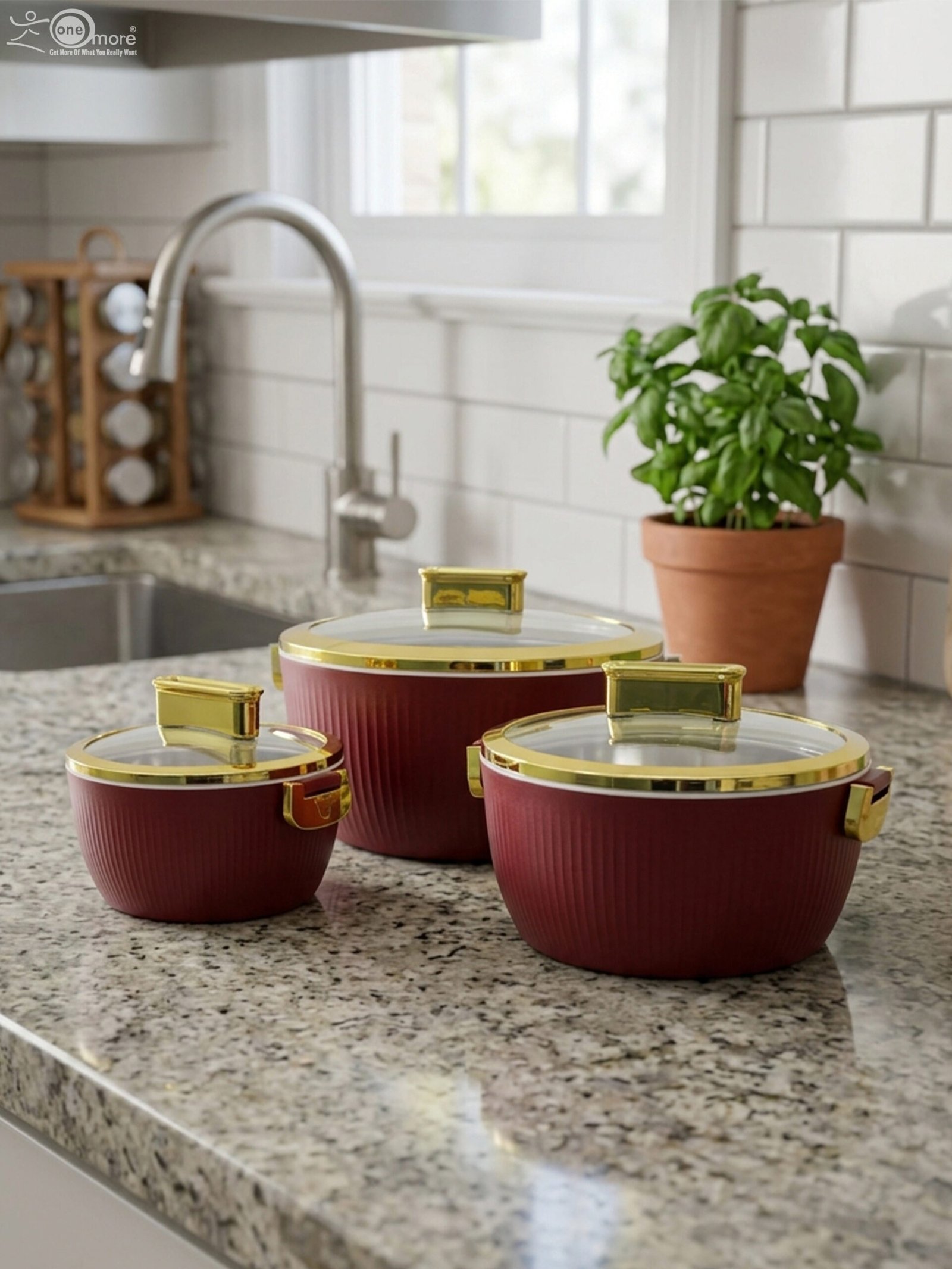 1 3-piece luxury insulated hotpot set in ribbed maroon with gold rims and clear glass lids on a granite kitchen countertop.