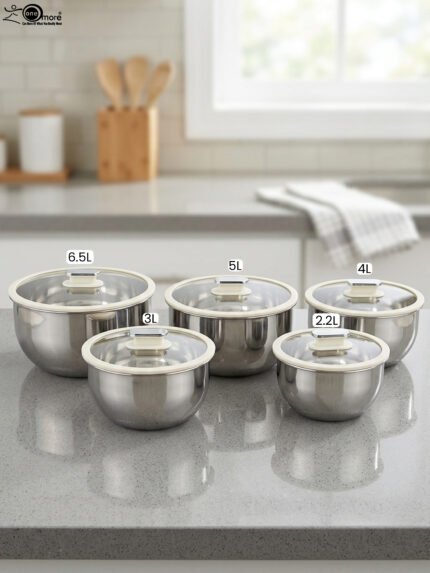 10 piece stainless steel mixing bowl set with clear glass lids sitting on a marble kitchen countertop