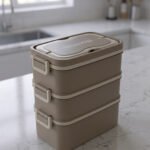 3-in-1 multi-tier beige and brown lunch box stacked on a kitchen countertop