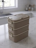 3-in-1 multi-tier beige and brown lunch box stacked on a kitchen countertop