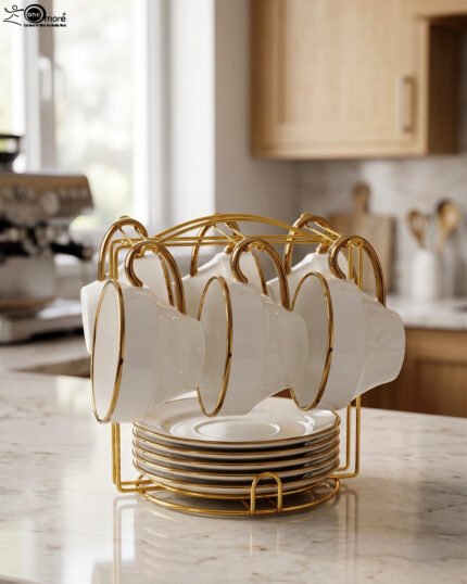 White ceramic tea cups and saucers neatly organized on a luxury golden stand on a marble kitchen countertop.