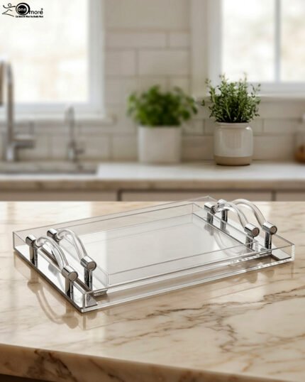 Clear acrylic serving tray set with polished handles displayed on a marble countertop in a modern kitchen setting