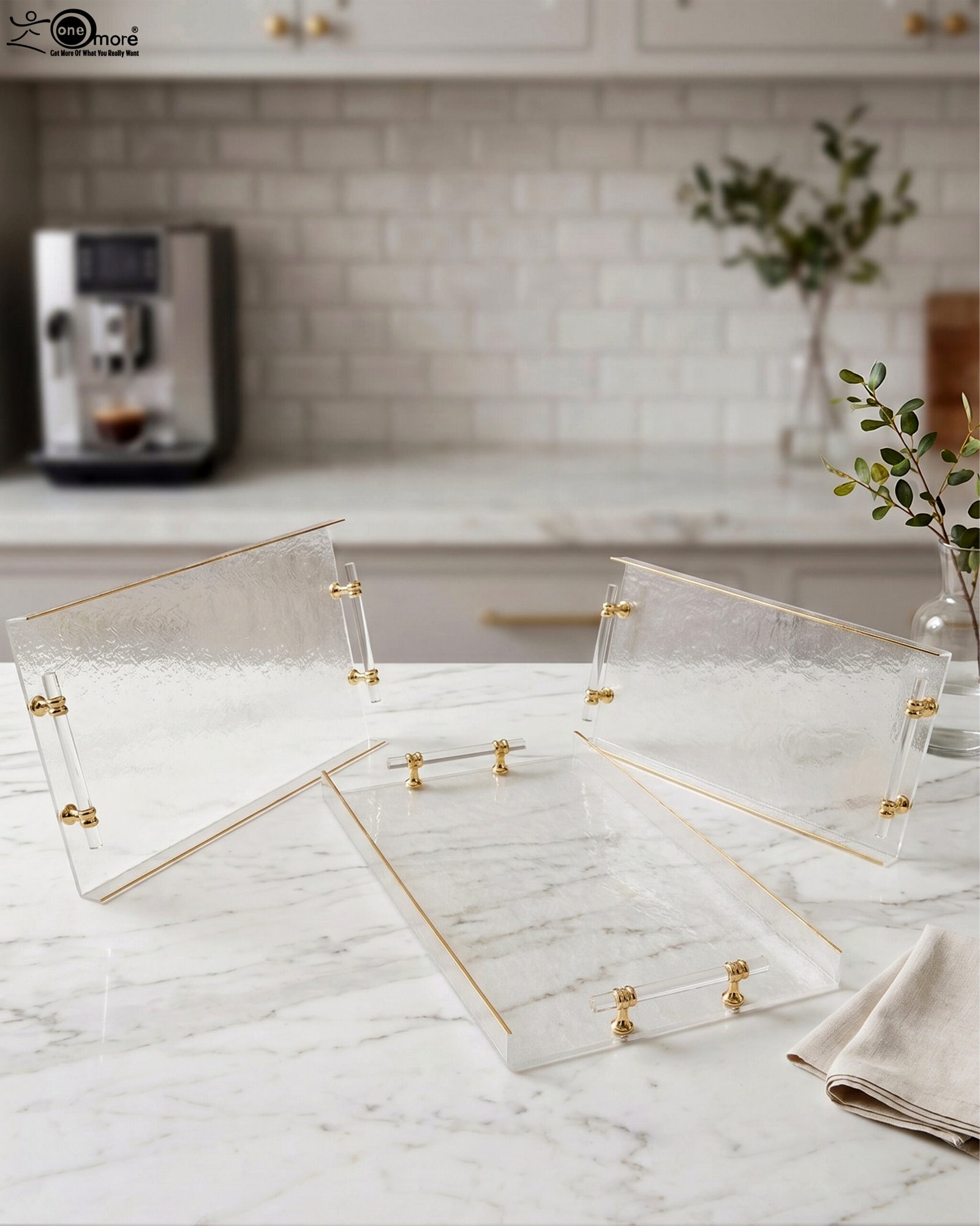 1 Clear acrylic tray set with textured glass look, gold accents, and transparent handles displayed on a white marble countertop.
