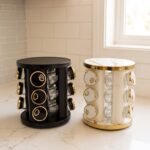 9-piece matte black and gold luxury spice rack set with clear glass bottoms on a granite countertop.