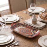 Vibrant 13-inch decorative Marrakech ceramic serving dish with colorful mosaic patterns and built-in side handles displayed on a wooden countertop.