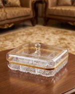 Two elegant crystal dry fruit dishes with gold rims and clear ball-knob lids, displayed in Medium and Large sizes on a table.