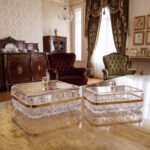 Two elegant crystal dry fruit dishes with gold rims and clear ball-knob lids, displayed in Medium and Large sizes on a table.
