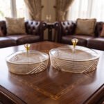 Medium and large luxury crystal dry fruit dishes with gold detailing and crystal-knob lids, displayed on a wooden coffee table.
