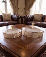 Medium and large luxury crystal dry fruit dishes with gold detailing and crystal-knob lids, displayed on a wooden coffee table.