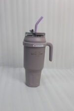 A row of colorful 1.5L stainless steel tumblers with handles and straws arranged on a kitchen counter.
