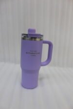 A collection of 900ml insulated "Nice Time Sitarayuri Coffee" tumblers with handles displayed in various colors on a kitchen counter.