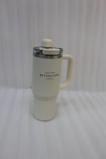 A collection of 900ml insulated "Nice Time Sitarayuri Coffee" tumblers with handles displayed in various colors on a kitchen counter.