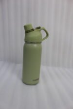 Four Dodge 630mL stainless steel water bottles in black, sage green, grey, and beige lined up on a kitchen counter.