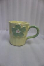 Four pastel ceramic coffee mugs with 3D floral designs lined up on a kitchen counter with cinematic lighting.