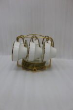 White ceramic tea cups and saucers neatly organized on a luxury golden stand on a marble kitchen countertop.