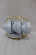 Luxury ceramic tea set with 6 cups, 6 saucers, and a golden stand on a kitchen counter