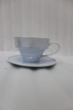 Luxury ceramic tea set with 6 cups, 6 saucers, and a golden stand on a kitchen counter