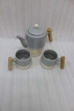 A stylish ceramic tea set in grey and white with wooden-style handles, consisting of six cups and one kettle, neatly arranged on a wooden tray display.