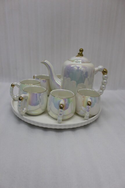 Luxury iridescent ceramic tea set with 6 cups, 1 kettle, and a rotating tray displayed on a marble kitchen counter