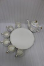 Luxury iridescent ceramic tea set with 6 cups, 1 kettle, and a rotating tray displayed on a marble kitchen counter
