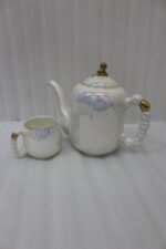 Luxury iridescent ceramic tea set with 6 cups, 1 kettle, and a rotating tray displayed on a marble kitchen counter