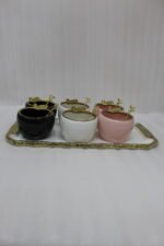 Luxury ceramic ice cream set with six multi-colored bowls and a gold-trimmed serving tray on a white marble kitchen counter
