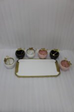 Luxury ceramic ice cream set with six multi-colored bowls and a gold-trimmed serving tray on a white marble kitchen counter