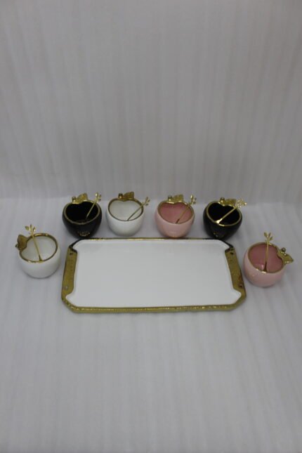 Luxury ceramic ice cream set with six multi-colored bowls and a gold-trimmed serving tray on a white marble kitchen counter