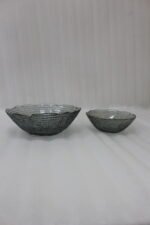 7-piece grey glass fruit set featuring one large serving bowl and six matching small bowls with gold rims, displayed on a kitchen countertop.
