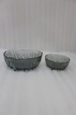 7-piece grey ribbed glass fruit set featuring one large serving bowl and six small bowls with elegant gold rims, displayed on a kitchen counter.