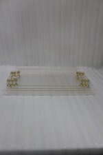 Clear acrylic tray set with textured glass look, gold accents, and transparent handles displayed on a white marble countertop.