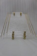 Clear acrylic tray set with textured glass look, gold accents, and transparent handles displayed on a white marble countertop.